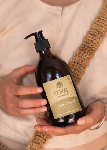 frasco de óleo corporal natural junto a saco de praia